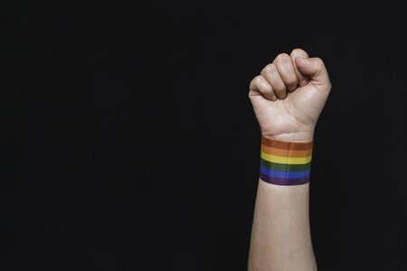 Rainbow flag bracelet arm of gay pride. Fist up with the gay pride flag. Pride. Rainbow bracelet....