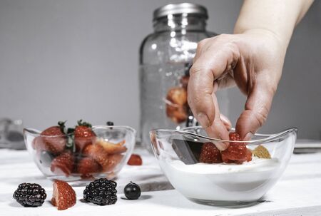 Greek yogurt granola and mixed berries. Blueberry and raspberry parfait. Homemade granola bowl with...