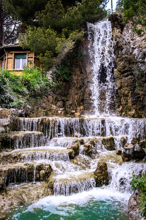 Beautiful waterfall near a colorful house. In Genoa, Italy.の写真素材
