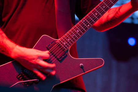 Guitarist playing the electric guitar during a solo show at a metal concertの写真素材