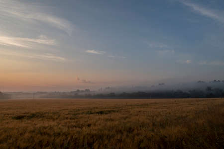 Sunrise against the backdrop of the mountains in the summer