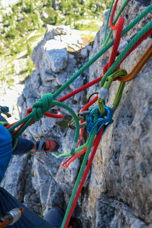 Climber with equipment while climbing in the mountainsの写真素材