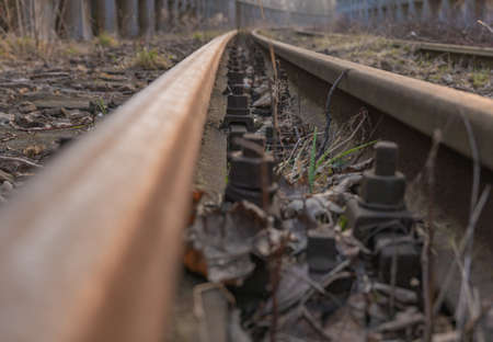 Old, dilapidated and abandoned railway station with rusty railway tracks and wooden railway sleepersの写真素材