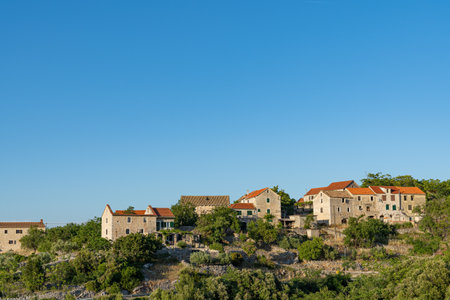 A small town on the slopes of the mountain island of Hvar in Croatiaの写真素材