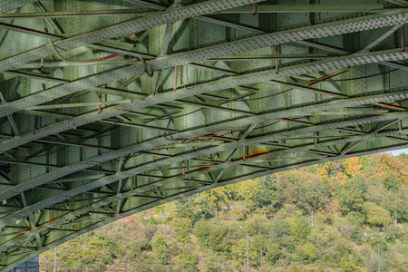 A beautiful old green steel bridge with a very interesting structure
