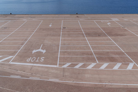 A huge empty, concrete, car park by the seaside.の写真素材