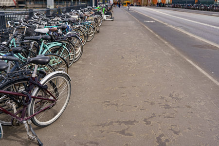 Densely parked various city bikes on the streetの写真素材