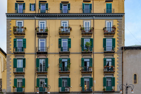 View of the beautiful old facade with beautiful windows and shuttersの写真素材