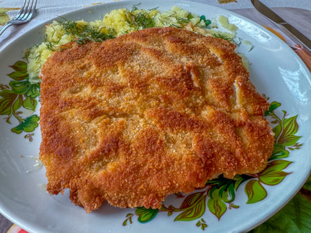 Polish, huge, pork chop with potatoes, served on a beautiful plateの写真素材