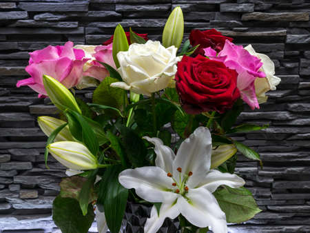 A colorful bouquet of roses on a gray stone backgroundの写真素材