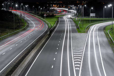 Highway at night with street lamps and carsの写真素材