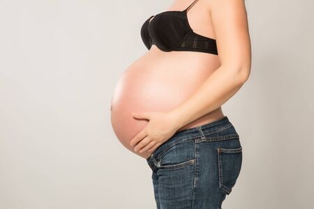 Pregnant woman with hands on her belly