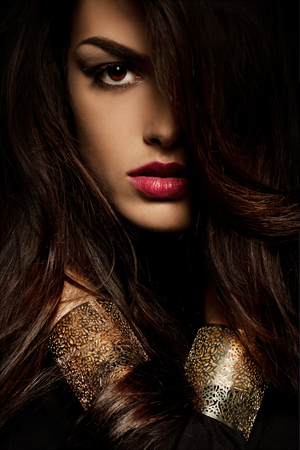 wild beautiful black hair woman shot with hair in motionの写真素材