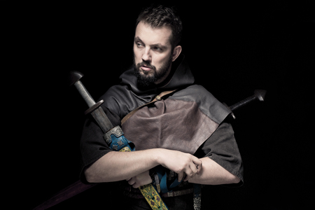 Viking warrior with sword over black background going to warの写真素材