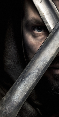 Viking warrior with sword over black background going to warの写真素材