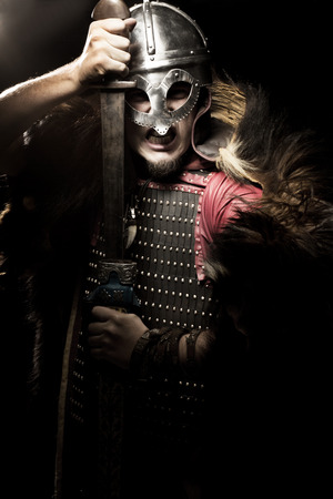 Viking warrior, male dressed in Barbarian style with sword, beardedの写真素材