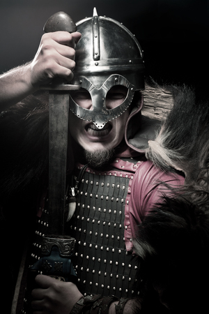 Viking warrior, male dressed in Barbarian style with sword, beardedの写真素材