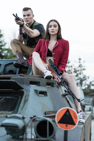 Shooting men sitting on the tank with a women near himの写真素材