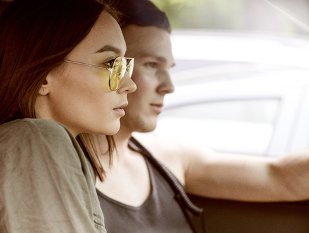 Sexy woman and man who drive a car.