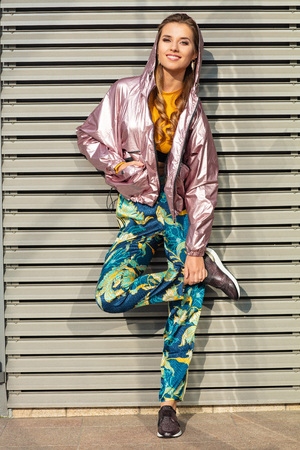 Pretty attractive and young woman posing on the street in colourful clothes.の写真素材
