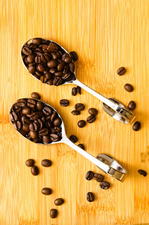 Aromatic coffee beans on spoonsの写真素材
