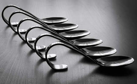 Evenly stacked teaspoons on the table.の写真素材