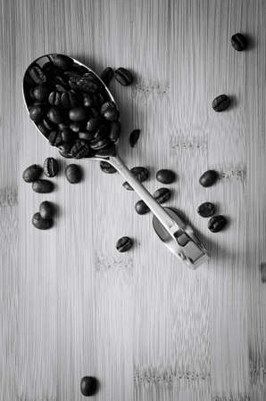 Aromatic coffee beans on spoonsの写真素材