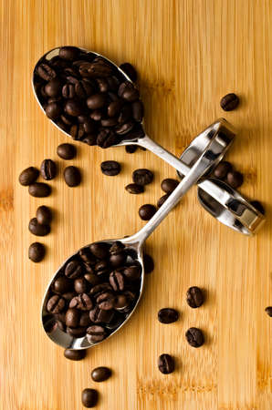Aromatic coffee beans on spoonsの写真素材