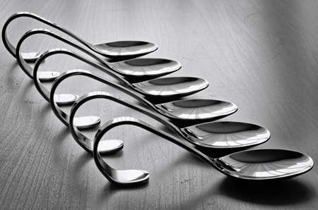 Evenly stacked teaspoons on the table.の写真素材