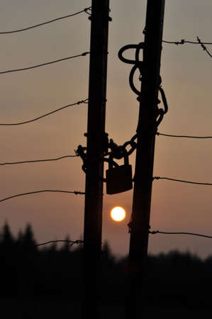 Sunset taken through locked gate.の写真素材