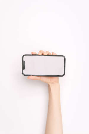 woman's hand holding a mobile phoneの写真素材