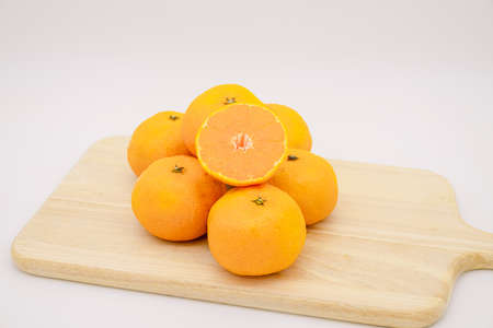 Many tangerines on a wooden boardの写真素材