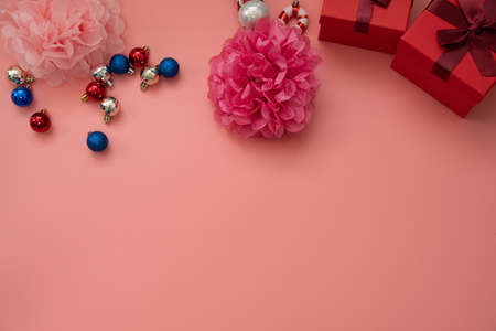 Christmas ornaments with flowers and gift box snowman on a pink backgroundの写真素材