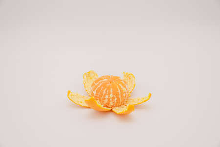 peeled tangerine over white backgroundの写真素材