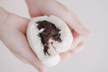 Hands slicing buns in halfの写真素材