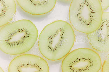 Kiwi slices and air bubblesの写真素材