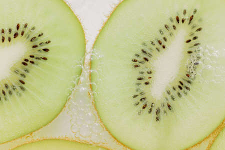 Kiwi slices and air bubblesの写真素材