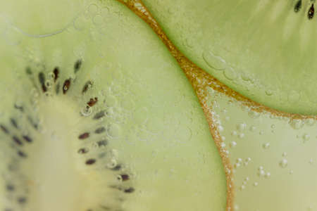 Kiwi slices and air bubblesの写真素材