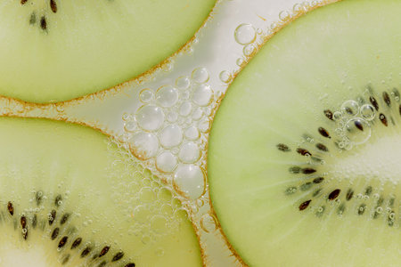 Kiwi slices and air bubblesの写真素材