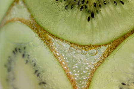 Kiwi slices and air bubblesの写真素材