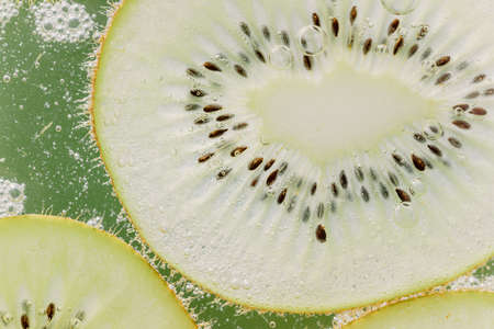 Kiwi slices and air bubblesの写真素材