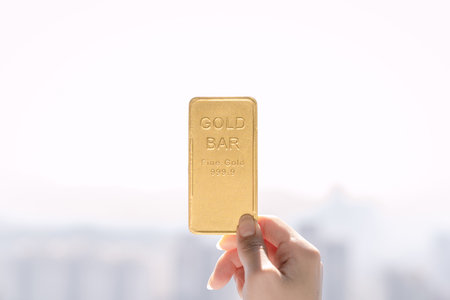 hand holding a gold barの写真素材