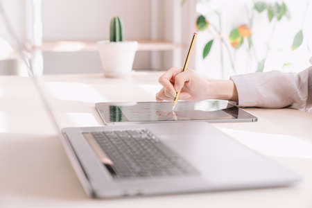 Office worker working with laptop and tabletの写真素材