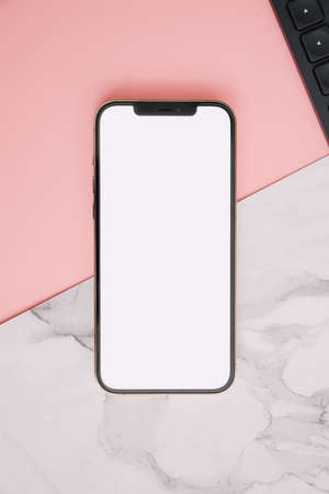 Mobile phone on a pink and marble backgroundの写真素材