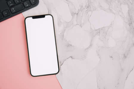 Mobile phone on a pink and marble backgroundの写真素材
