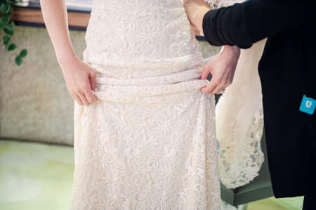 bride holding wedding dress