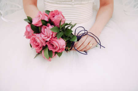 Bride in wedding dress holding bouquetの写真素材