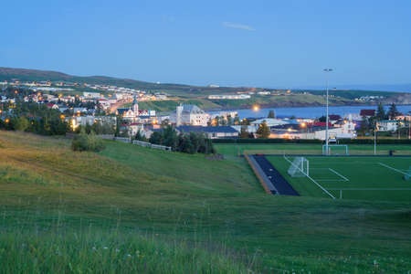 View of Husavik in the evening dusk from the grasslands near the campの写真素材