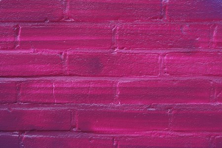Brick wall painted of purplt color (clouse up of graffitti)の写真素材