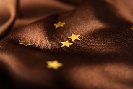 Silk textile chocolate background with stars (short focus)